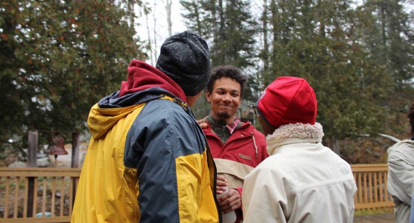 Three people speak to each other at the family seminar of an outward bound intercept course